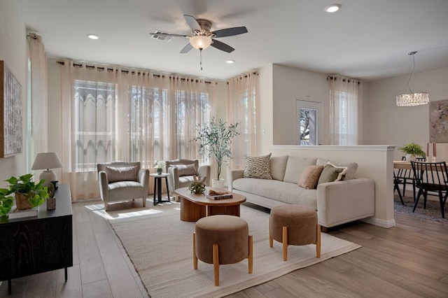 living area featuring visible vents, recessed lighting, a ceiling fan, and wood finished floors