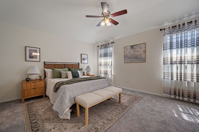 carpeted bedroom featuring baseboards and a ceiling fan