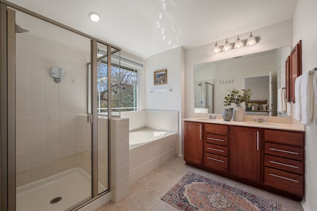 bathroom with tile patterned floors, a garden tub, a sink, a shower stall, and double vanity