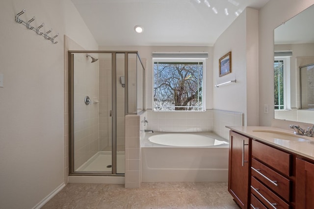 full bathroom with a bath, a shower stall, and vanity