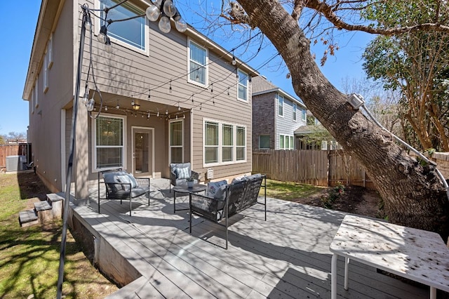 rear view of house with a deck, central air condition unit, fence, and an outdoor hangout area