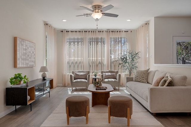 living room featuring recessed lighting, baseboards, a ceiling fan, and wood finished floors