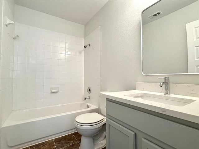 bathroom featuring visible vents, toilet, shower / tub combination, tile patterned floors, and vanity