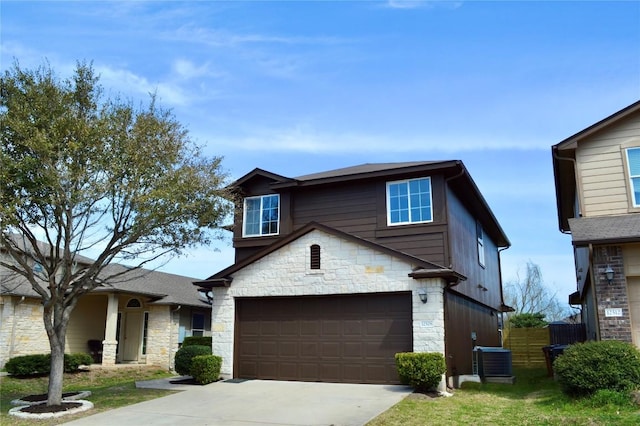 view of front of property with cooling unit, stone siding, concrete driveway, and an attached garage