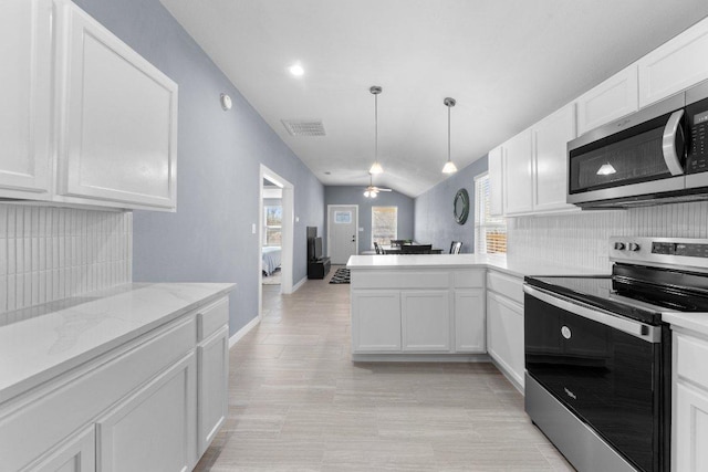 kitchen with visible vents, a peninsula, white cabinets, stainless steel appliances, and a ceiling fan