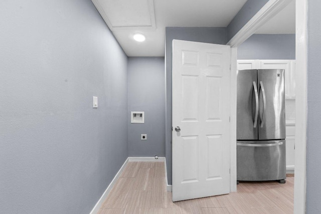 laundry area featuring electric dryer hookup, washer hookup, light wood-style flooring, and laundry area