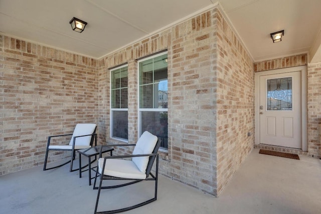 entrance to property featuring brick siding