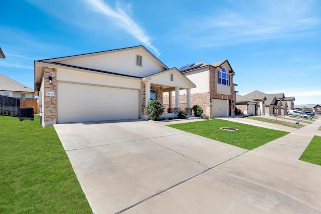 view of front of house with brick siding, fence, concrete driveway, a front yard, and a garage