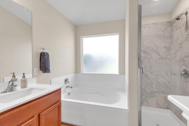 full bathroom featuring a bath, a stall shower, and vanity