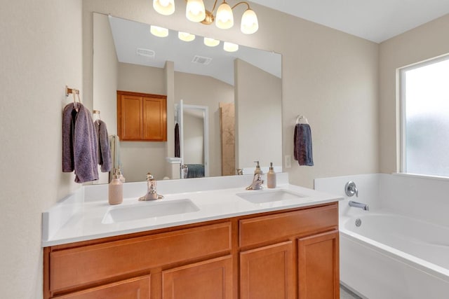 bathroom with a wealth of natural light, visible vents, and a sink