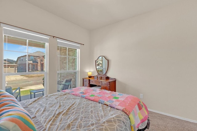 carpeted bedroom with baseboards