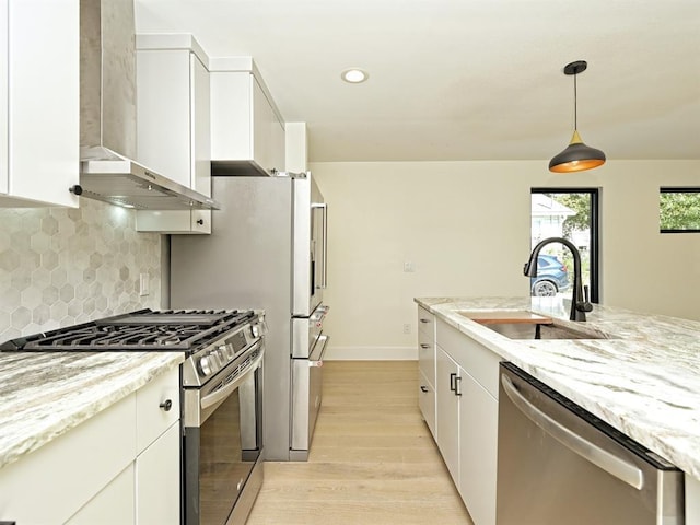 5010 Rowena Ave Unit 1, Austin, TX 78751 - kitchen featuring a sink, appliances with stainless steel finishes, light wood-style floors, wall chimney exhaust hood, and backsplash