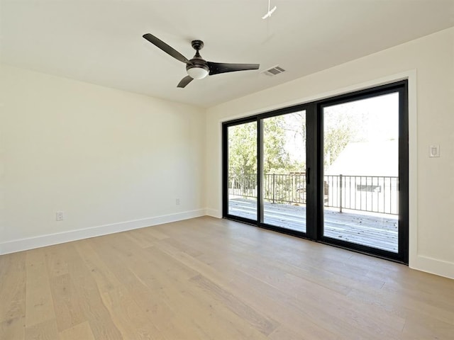 spare room with light wood-style flooring, visible vents, baseboards, and ceiling fan