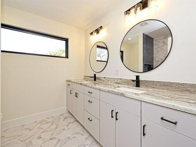 5010 Rowena Ave Unit 1, Austin, TX 78751 - full bathroom featuring double vanity, marble look tiles, baseboards, and toilet