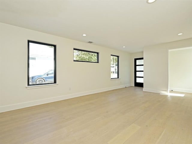 empty room featuring visible vents, recessed lighting, light wood-type flooring, and baseboards