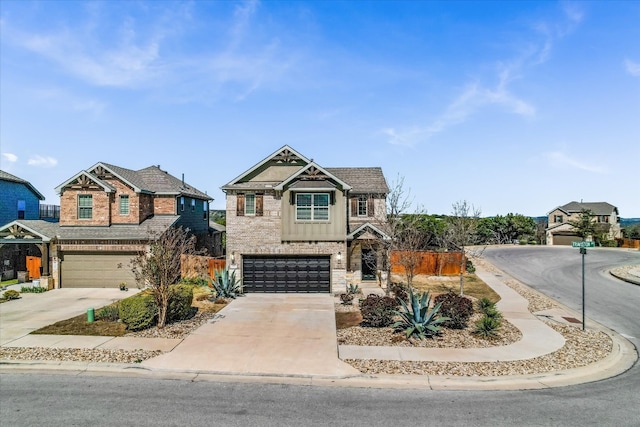 craftsman inspired home featuring an attached garage, concrete driveway, and fence