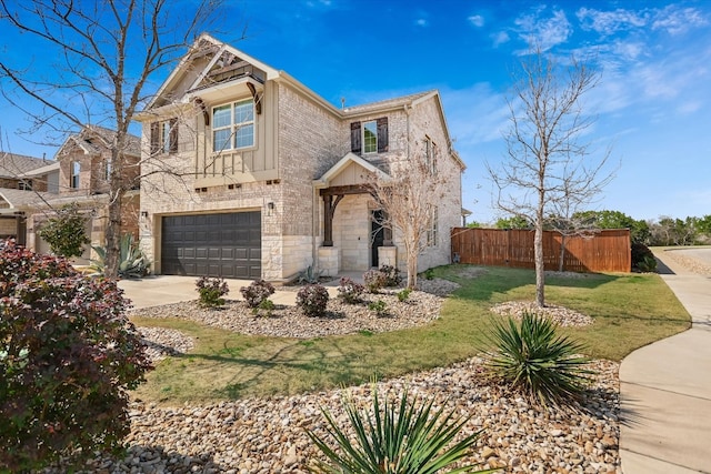 view of front of house featuring a front yard, fence, concrete driveway, a garage, and stone siding