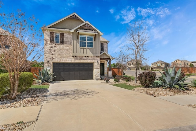 craftsman-style house featuring brick siding, board and batten siding, fence, concrete driveway, and a garage