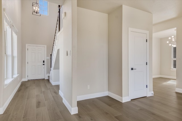 5300 Traviston Dr, Austin, TX 78738 - entrance foyer featuring a chandelier, wood finished floors, and baseboards