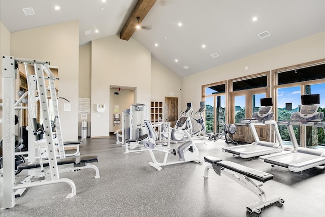 exercise room with visible vents, baseboards, and high vaulted ceiling