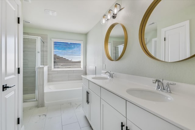 full bathroom with double vanity, marble finish floor, a shower stall, and a sink