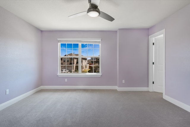 empty room featuring baseboards, carpet, and ceiling fan