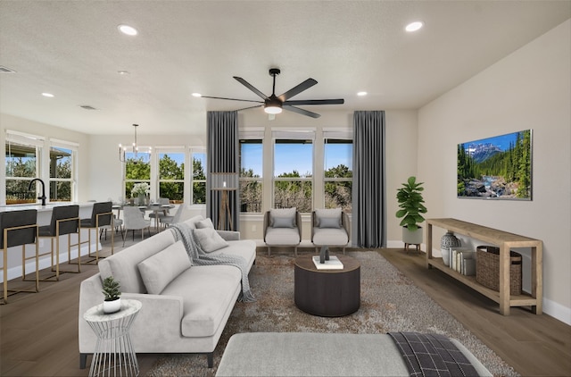 5300 Traviston Dr, Austin, TX 78738 - living area with recessed lighting, baseboards, wood finished floors, ceiling fan, and a chandelier