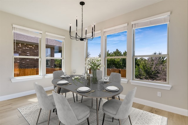 5300 Traviston Dr, Austin, TX 78738 - dining area featuring a chandelier, baseboards, and light wood-type flooring