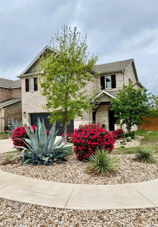 5300 Traviston Dr, Austin, TX 78738 - view of front of house with brick siding and a garage