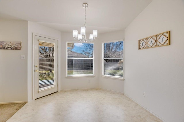 unfurnished dining area featuring a wealth of natural light, baseboards, and an inviting chandelier