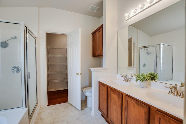 full bath featuring double vanity, visible vents, a shower stall, and a sink