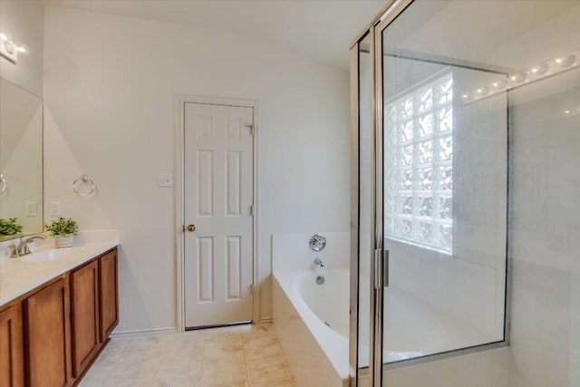 full bath with vanity and a garden tub