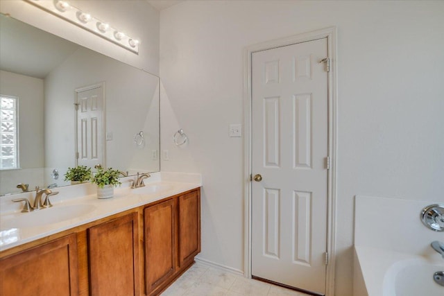 full bathroom with a bathtub, vaulted ceiling, double vanity, and a sink