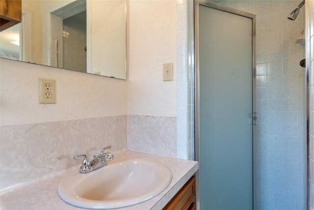 bathroom featuring vanity and a shower stall