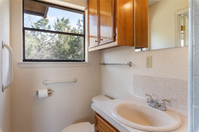 half bathroom with toilet and vanity