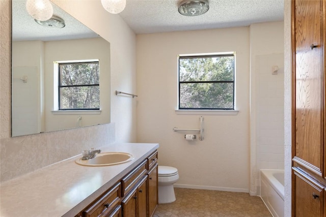 full bathroom with a wealth of natural light, toilet, vanity, and baseboards