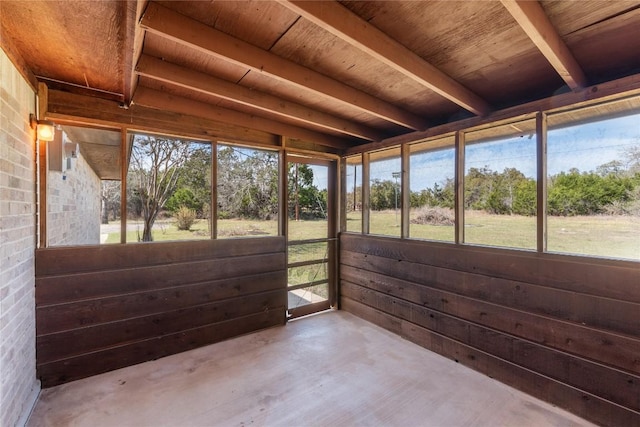 unfurnished sunroom featuring plenty of natural light and wood ceiling