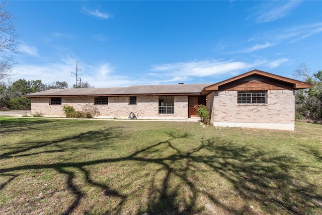 ranch-style house with brick siding and a front lawn