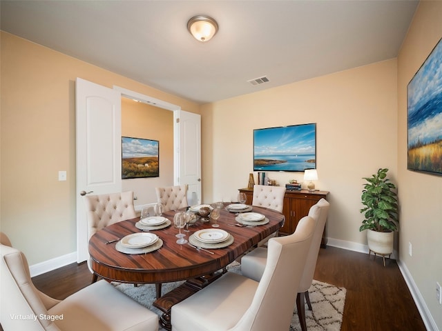 dining area with baseboards, visible vents, and dark wood-style flooring