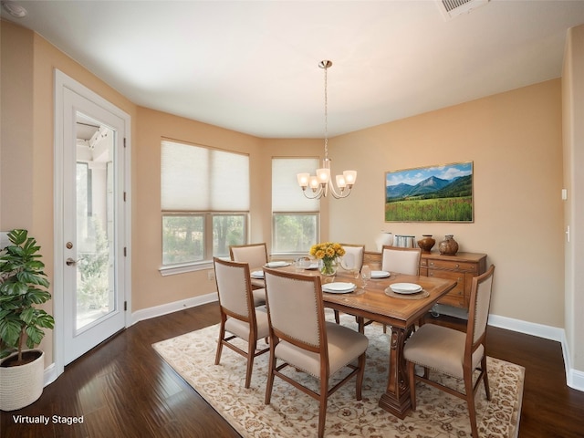 dining area featuring an inviting chandelier, baseboards, dark wood-type flooring, and visible vents