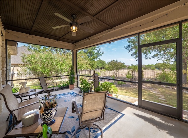 sunroom featuring a ceiling fan