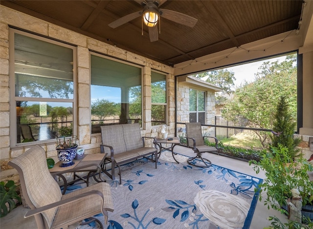 sunroom / solarium with wood ceiling and ceiling fan