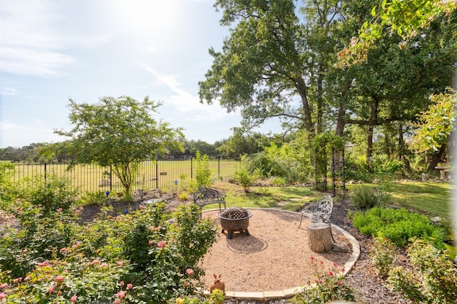 view of yard with an outdoor fire pit and fence