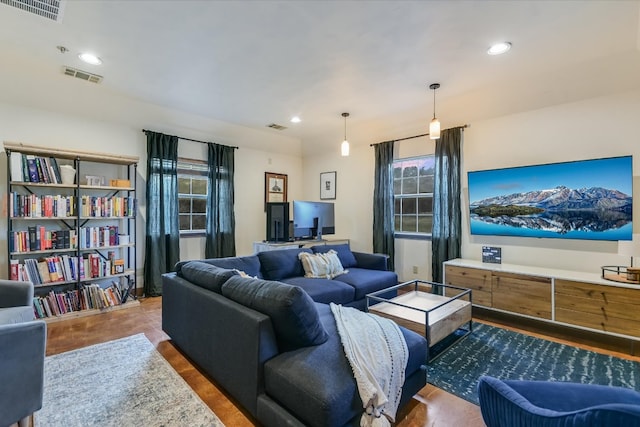 living area featuring recessed lighting and visible vents