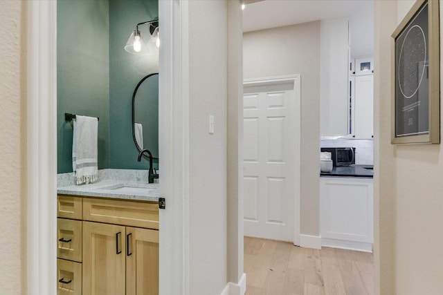 bathroom featuring wood finished floors and vanity