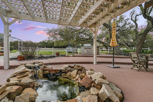 patio terrace at dusk with a pergola