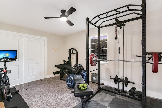 exercise area with baseboards and a ceiling fan