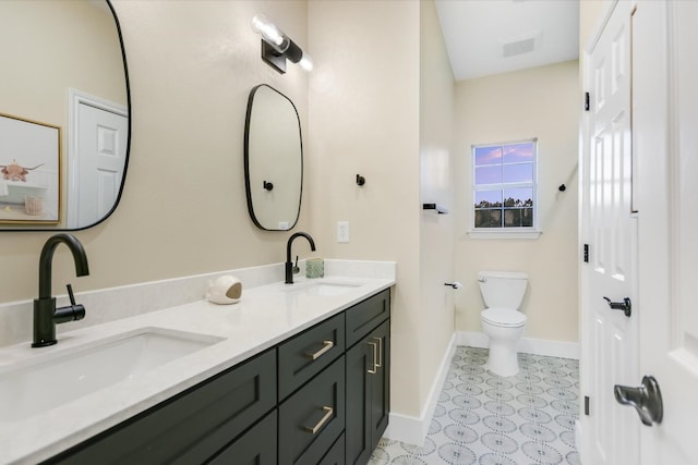 bathroom with a sink, visible vents, baseboards, and toilet