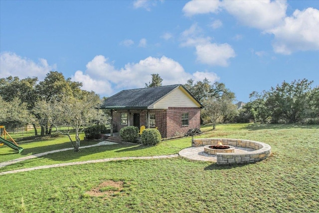 exterior space with a playground and a fire pit