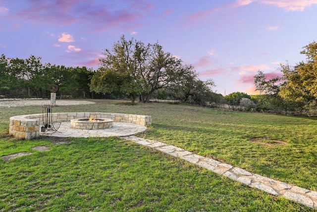 yard at dusk with a patio and a fire pit